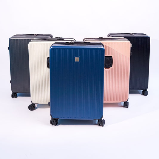 Set of five suitcases in different colors on a white background